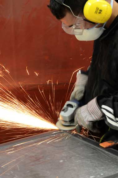 craftsman grinding welded steel picture frame